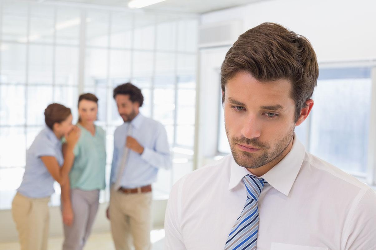 Group of co-workers gosspiing about another co-worker
